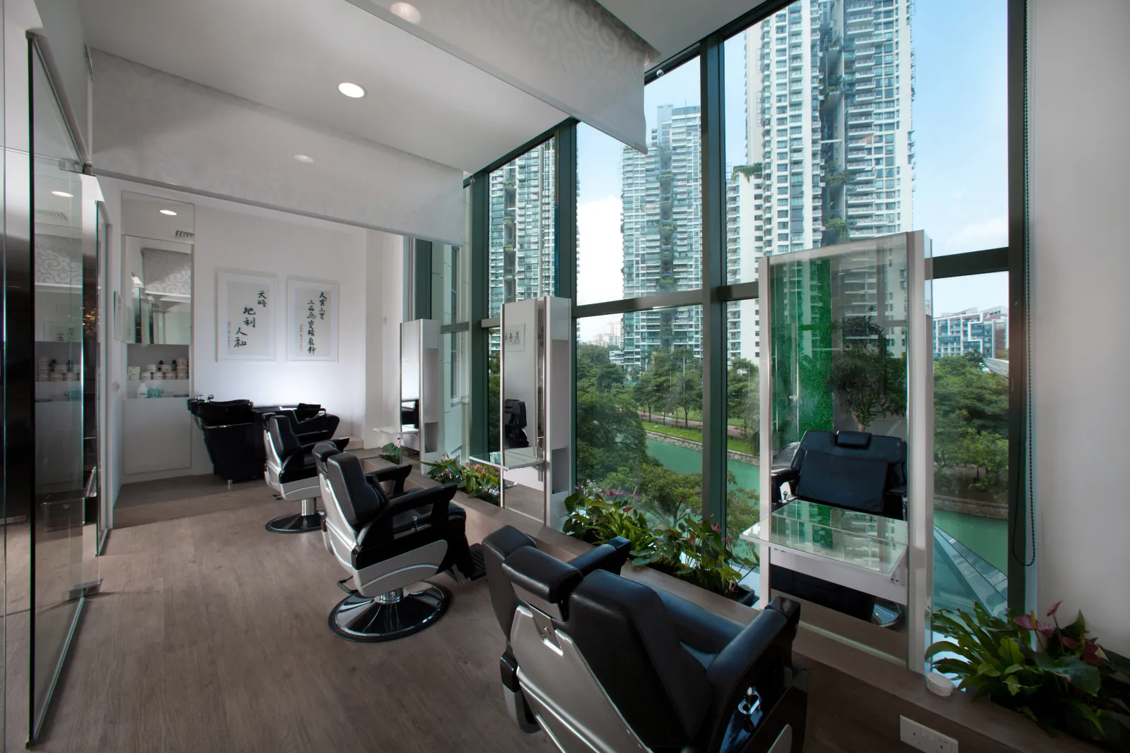 Styling stations framed by floor-to-ceiling windows over the Singapore River
